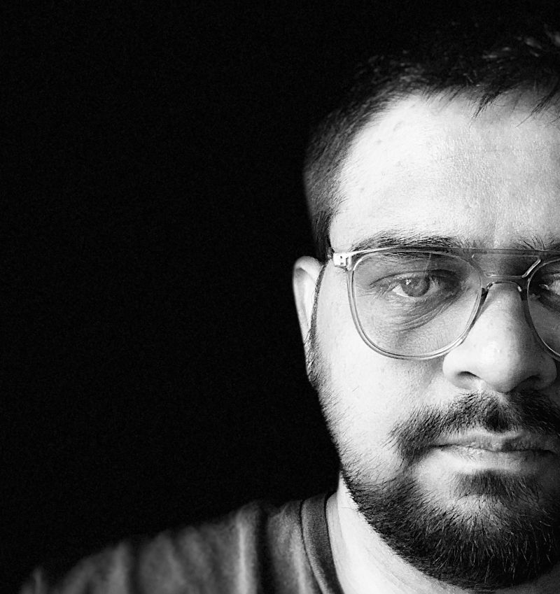 Black and white portrait of Harsh Mistry wearing glasses